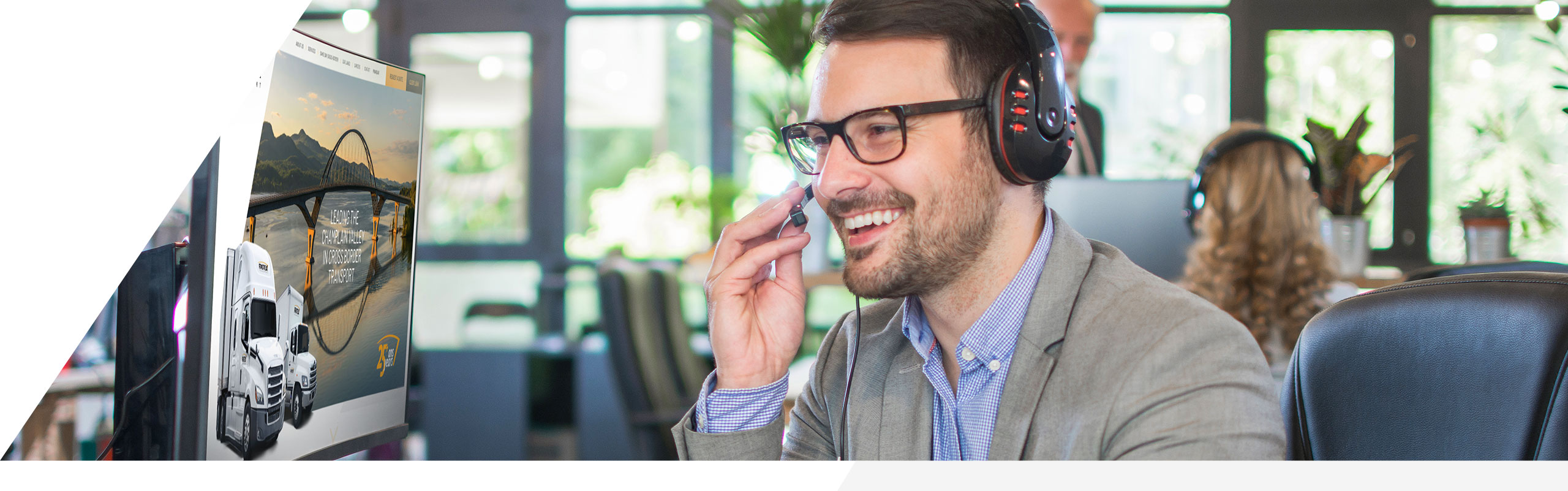 A customer service representative talking on a headset, looking at a computer screen.